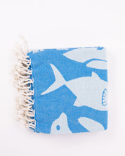 A blue and white Ocean Explorer Turkish Towel with fish on it from Cognitive Surplus.
