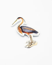 A Purple Heron Sticker from Cognitive Surplus is standing on a white surface.