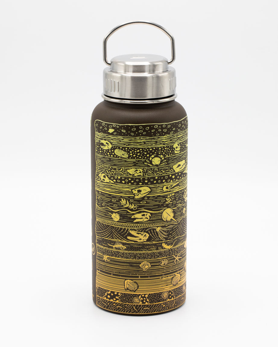 A Core Sample 32 oz Steel Bottle by Cognitive Surplus with a gold and brown design.