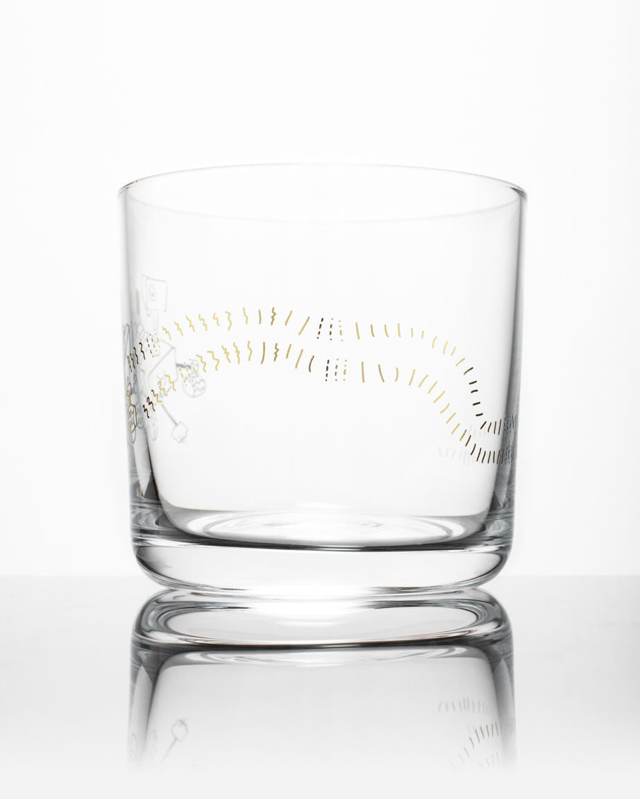 A SECONDS: Mars Rover Perseverance Whiskey Glass with a gold design on it by Cognitive Surplus.